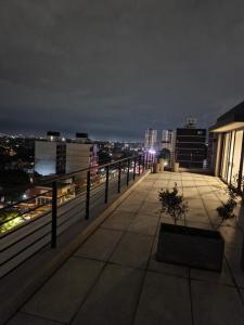 a balcony with a view of a city at night at Nuevo, opción parking, hasta 5 personas in Montevideo