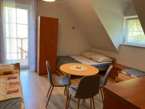 a room with a table and chairs and a bed at Dańczówka in Lewin Kłodzki