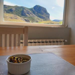 a bowl of food sitting on a table in front of a window at Los Coirones Aparts - El Chaltén - Patagonia in El Chalten