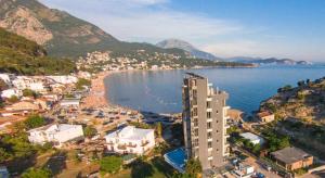 an aerial view of a city and the ocean at Hostel Marina in Sutomore