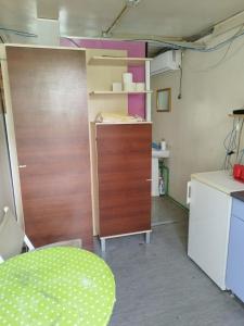 a room with a kitchen with a table and a cabinet at Hostel Marina in Sutomore