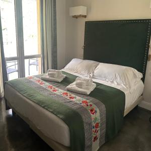 a bedroom with a bed with two towels on it at Kemani Villa Sara Olbia in Olbia