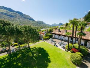 an aerial view of a resort with mountains in the background at Apartment Villaggio Sureggio - App- C1 by Interhome in Lugaggia