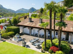 an aerial view of a villa with palm trees at Apartment Villaggio Sureggio - App- C1 by Interhome in Lugaggia