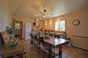 a kitchen with a table and chairs in a room at La maison de claire in Saint-Ouen-sur-Gartempe