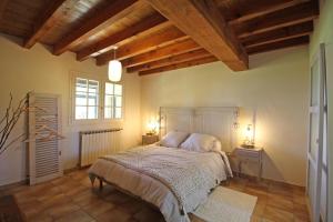 ein Schlafzimmer mit einem Bett in einem Zimmer mit Holzdecken in der Unterkunft La maison de claire in Saint-Ouen-sur-Gartempe