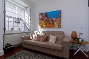- un salon avec un canapé et un tableau mural dans l'établissement GuestReady - Ribeira Apt in Porto center, à Porto