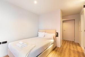 a white bedroom with a bed with white sheets at GuestReady - Stylish studio in Gaia in Vila Nova de Gaia