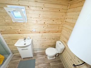 a small bathroom with a toilet and a sink at Maringotka na kraji rybníka 