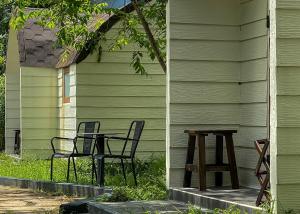 two chairs and a table in front of a house at Cottage Retreat DALAT in Da Lat
