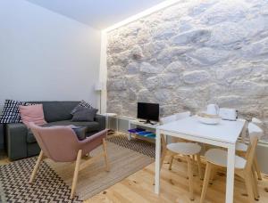 een woonkamer met een witte tafel en een bank bij GuestReady - Charming Downtown and Quiet Apartment in Porto