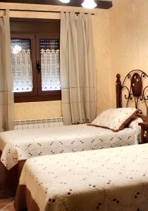 two twin beds in a bedroom with a window at 2 bedrooms house at Hueva in Hueva