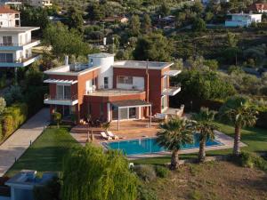 an aerial view of a house with a swimming pool at 3 Palm Villa in Chalkida