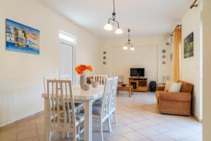 a dining room and living room with a table and chairs at Villa Sunlights Bali in Balíon
