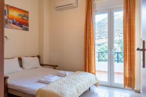 a bedroom with a bed and a large window at Villa Sunlights Bali in Balíon +30 photos