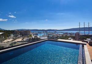 a swimming pool with a view of a harbor at Porto Palace in Tivat