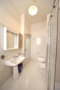 a bathroom with a sink and a toilet and a shower at Casa Vacanze Rocca dei Papi in Montefiascone