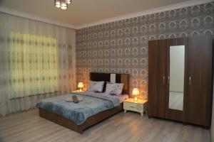 a bedroom with a bed and a large mirror at Panorama of the Mountains in Gabala +21 photos