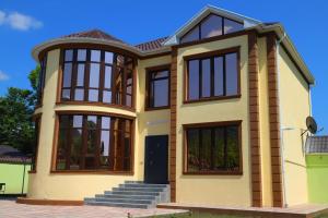 a large house with windows at Panorama of the Mountains in Gabala