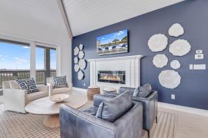 a living room with blue walls and a fireplace at Casa De Coconuts in Padre Island