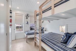 a bedroom with two bunk beds and a window at Casa De Coconuts in Padre Island