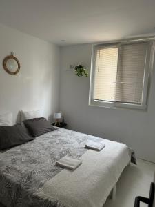 a bedroom with a bed with two towels on it at Location In private security residence with free parking, 1 minute from tramway, 9 minutes from de center, accessible all transports in Nice