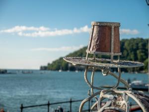 a metal bird bath next to a body of water at Waterfront House in Dartmouth