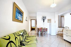 a living room with a couch and a table at One bedroom house with shared pool enclosed garden and wifi at Vibo Valentia in Parghelia