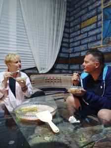 a man and woman sitting at a table eating food at Petra Anas House in Wadi Musa