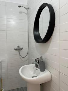 a bathroom with a sink and a mirror on the wall at Villa B&E 2 in Vlorë +13 photos