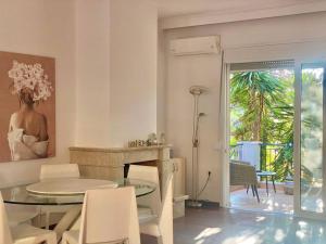a dining room with a table and a table and chairs at Corfu Dream Holidays Villas Kanoni in Kanoni