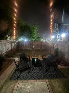 a group of chairs and a table in a yard at night at King's Camp - SEAWORLD and MEDICAL Center, Yard, BBQ, Garage in San Antonio