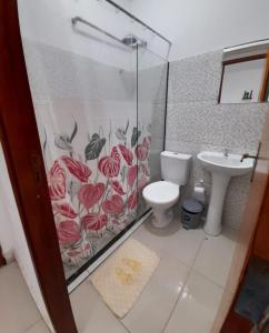 a bathroom with a shower and a toilet and a sink at Central Palace Hotel in Fortaleza