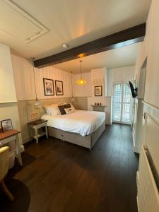 Woolpack Inn في كانتربيري: غرفة نوم بسرير كبير في غرفة