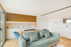 a living room with a couch and a table at GuestReady - Central Park in Porto in Porto +23 photos