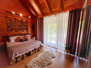 a bedroom with a bed and a dog laying on the floor at Villa Logu in Theth +17 photos
