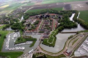 an aerial view of a city with a harbor at Hotel Willemstad in Willemstad