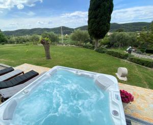 a hot tub sitting on a table in a yard at Holiday Home Vintage in Supetarska Draga