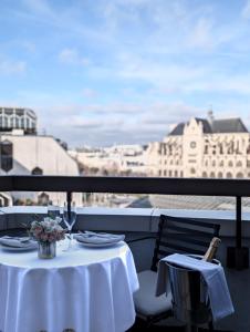 a table on a balcony with a view of the city at Novotel Paris Les Halles in Paris