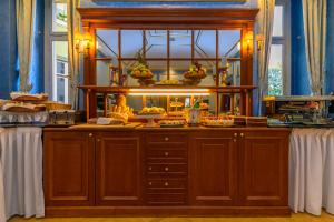 a table with a buffet of food on it at Hotel Kinsky Fountain in Prague
