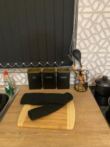 a cutting board with two pillows on a kitchen counter at Cosy Home In Nottingham Near QMC and University Free Parking! in Nottingham