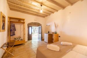 a living room with a table and a kitchen at Mylos Seaside Experience in Frangokastello