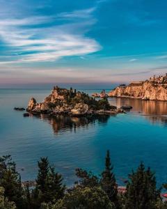 an island in the middle of the water at Magda Dom in Taormina