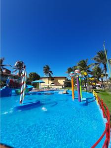 a large swimming pool with a water park at JL Temporadas - Quarto Portobello Park Hotel in Porto Seguro