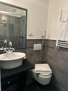 bagno con lavandino, servizi igienici e specchio di Affittacamere 4 bassotti a Monterosso al Mare