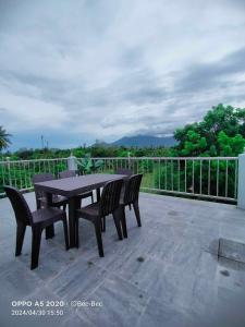 a black table and chairs on a patio at White House Villa in Dumaguete