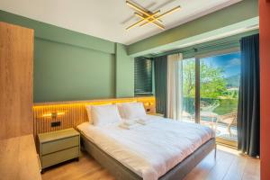 a bedroom with a bed and a large window at Premium park rezidans in Kemer +69 photos