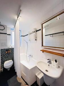 a white bathroom with a sink and a toilet at Central City West 3 in Berlin