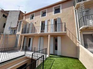 a building with stairs and grass in front of it at Rebeca - 4 pers Standing - Hyper centre -Terrasse in Saint-Raphaël
