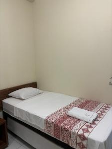 ein Bett in einem Zimmer mit zwei Handtüchern darauf in der Unterkunft San Felipe Hotel in Colinas do Tocantins
